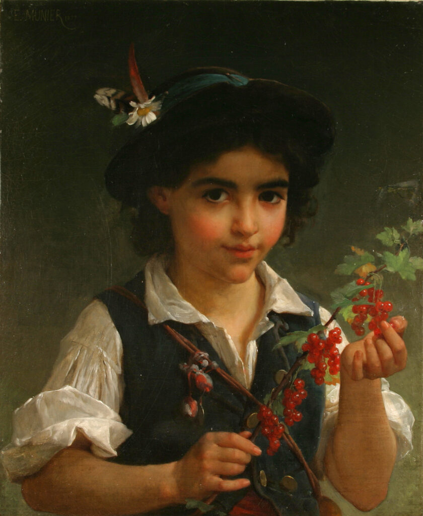 A young boy holding a branch with red currents