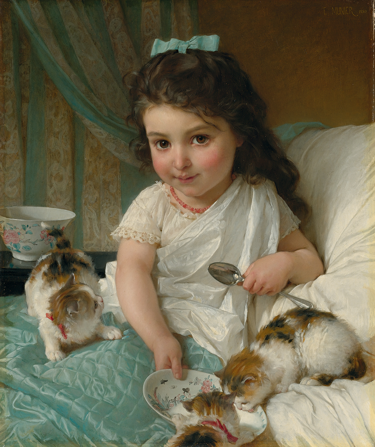 A young girl in bed with some kittens